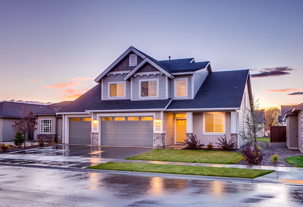 Elegant suburban home with driveway at sunset showcasing modern architecture.